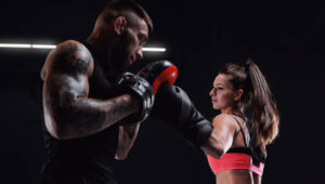 athletic-woman-red-shorts-top-is-boxing-with-trainer-boxing